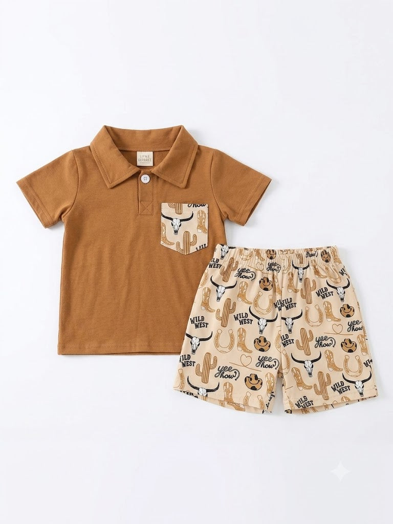 Boys 2-piece Wild West short set featuring a caramel brown short-sleeve polo with a western-print chest pocket, paired with cream shorts with an all-over Wild West print including bull skulls, cacti, cowboy hats, horseshoes, and "Yee Haw" lettering