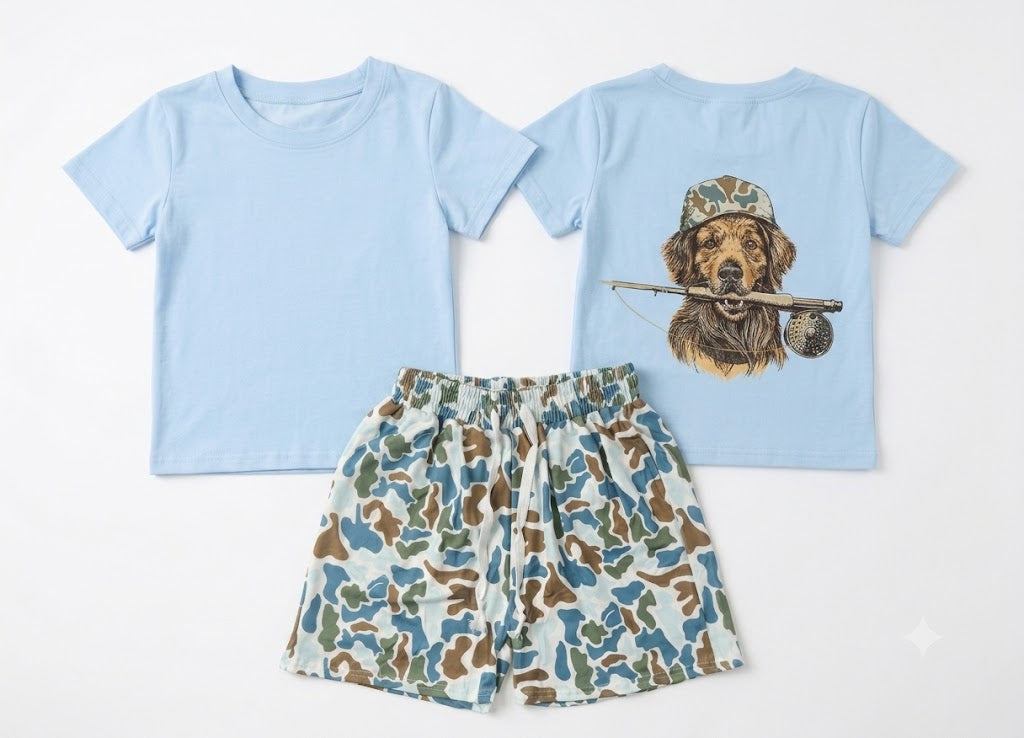 Children's light blue short sleeve tee with golden retriever fishing graphic on the back, paired with green and brown camo drawstring shorts — front and back view"