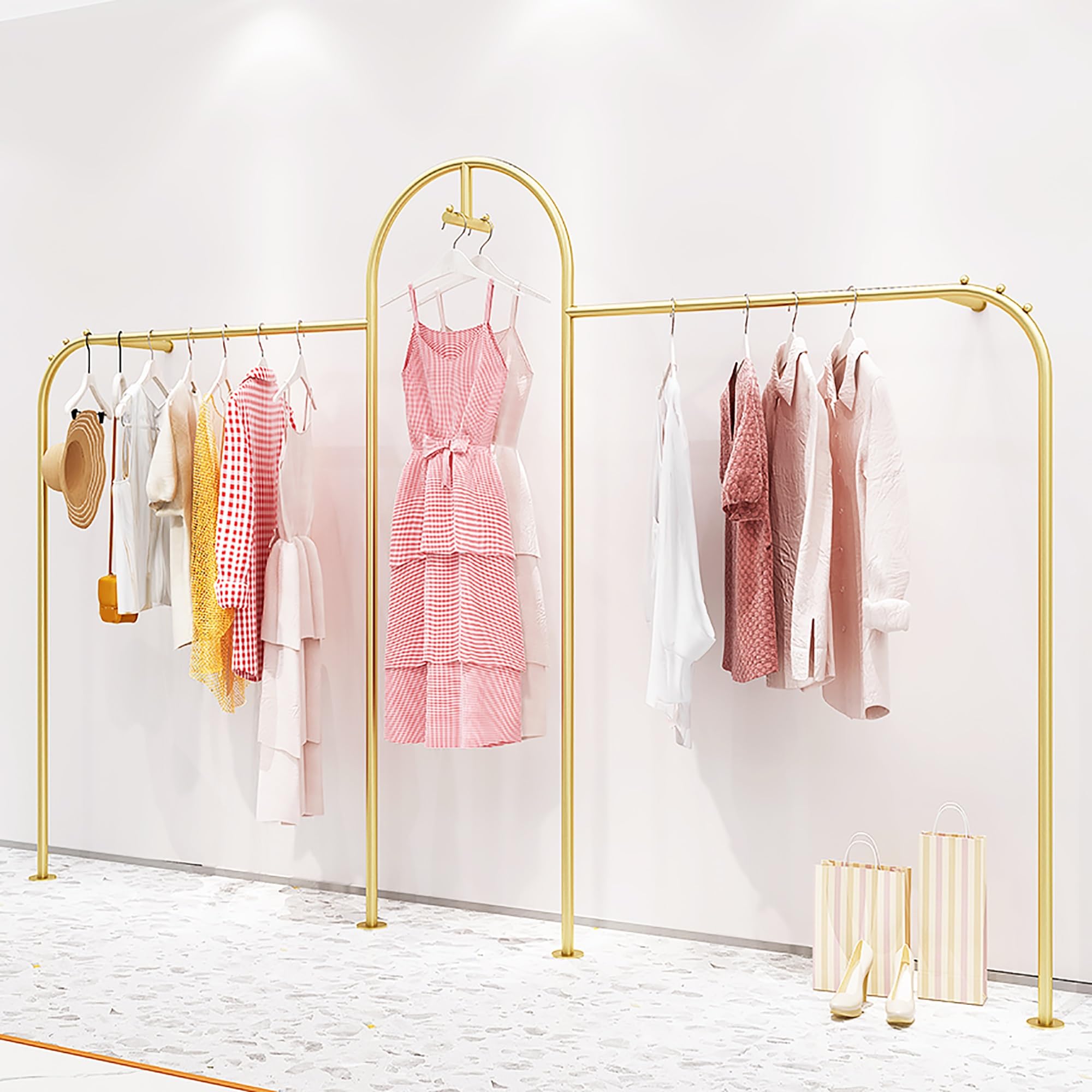 Gold clothing rack with dresses on a white background