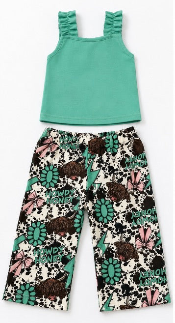 A two-piece toddler girl's outfit set featuring a solid mint green sleeveless top with ruffled shoulder straps and matching floral print pants with a cow print background.