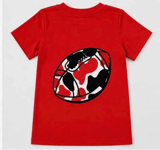 A red short-sleeve kids' t-shirt featuring a large graphic of a football with a red, black, and white cow print on the front, displayed against a light gray background.